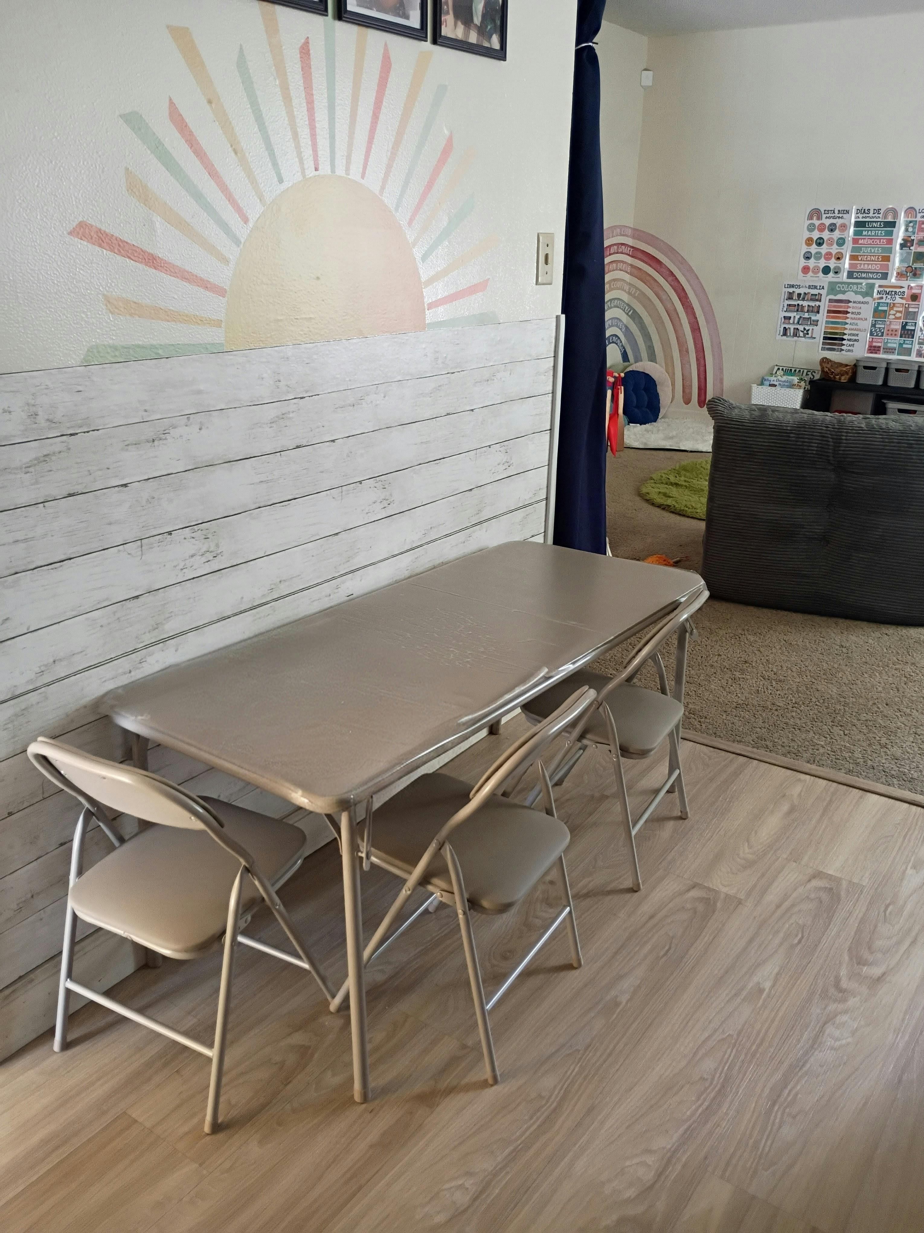 Small folding table and chairs for children in a room