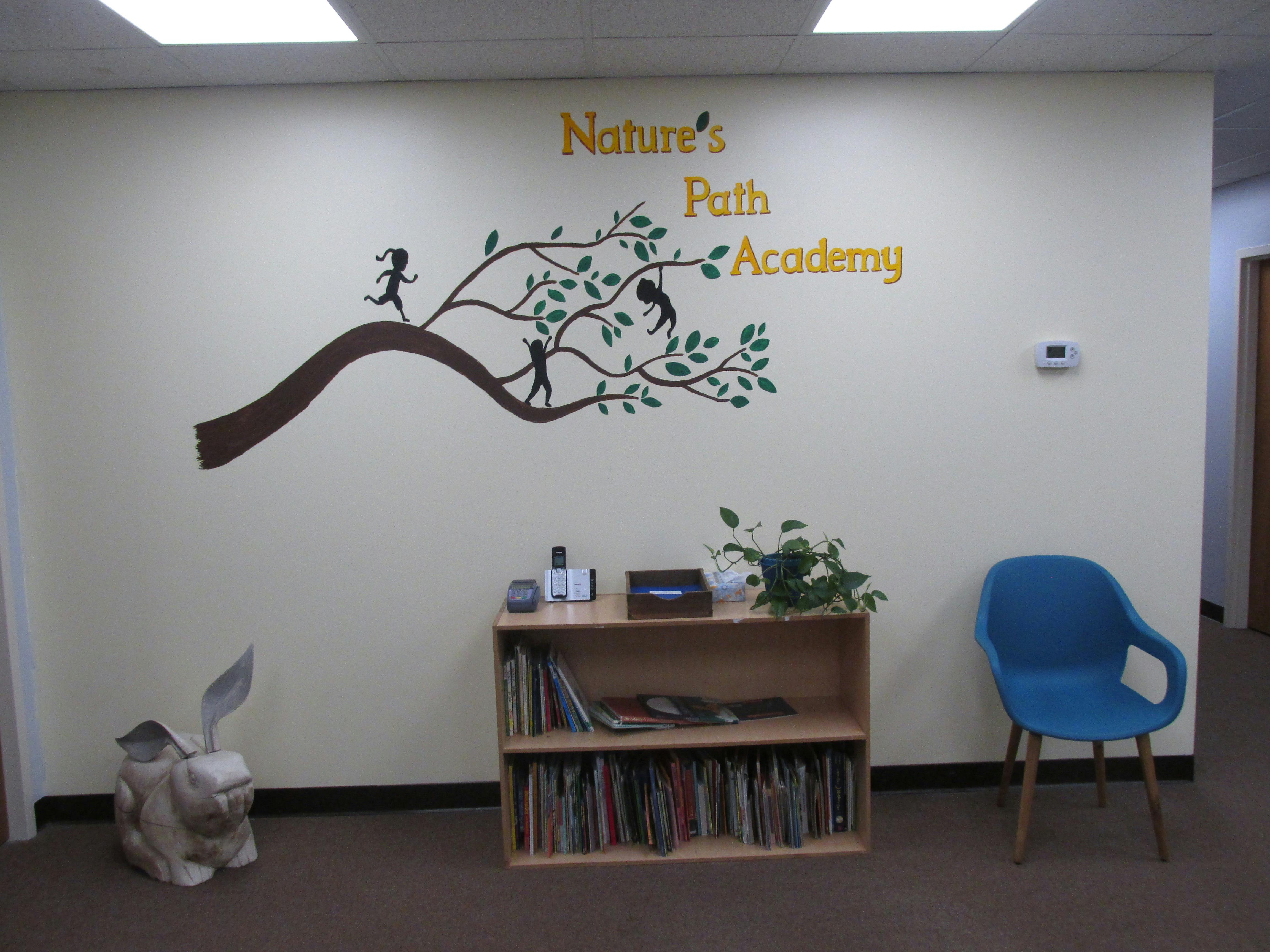 Wall decal of a tree with figures and "Nature's Path Academy" text