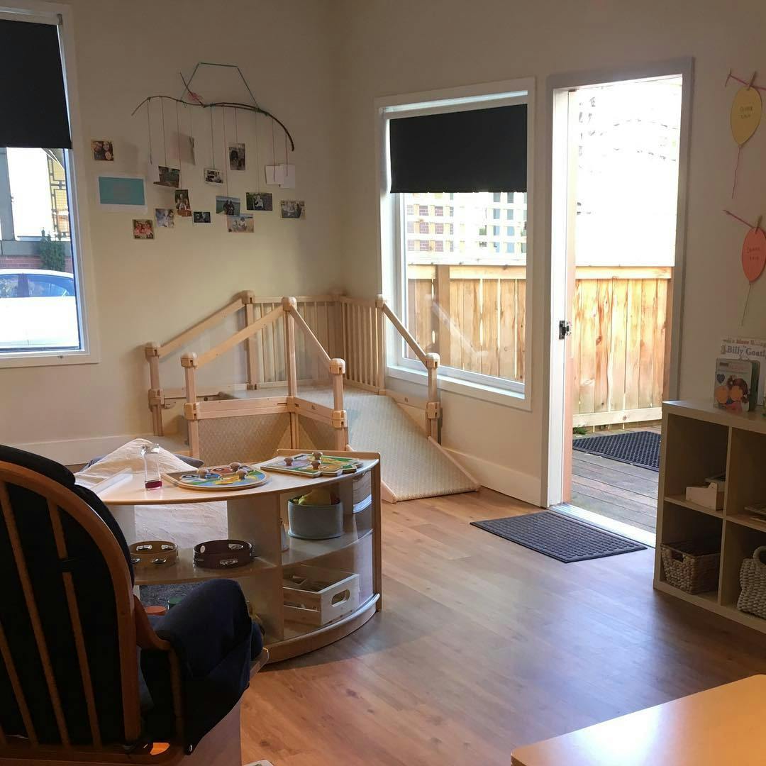 Indoor play area with a wooden bridge and slide structure
