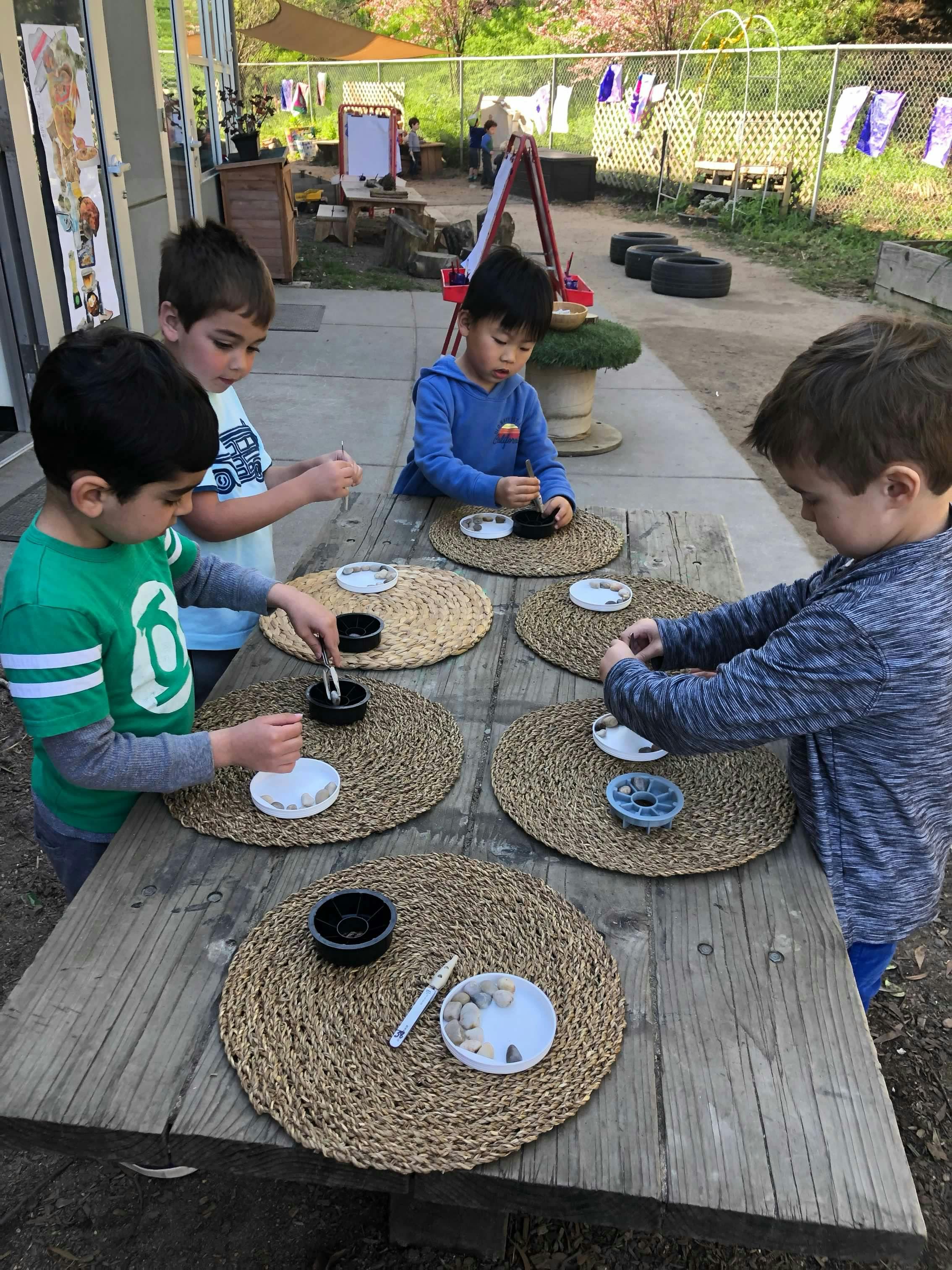 Four children at a table with craft supplies
