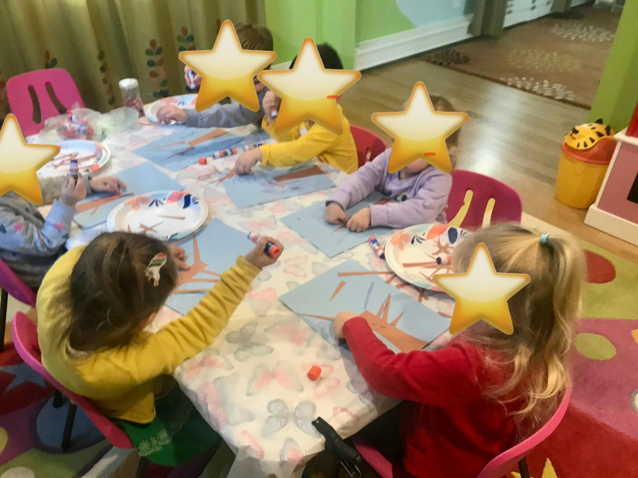 Children sitting at a table doing an art activity