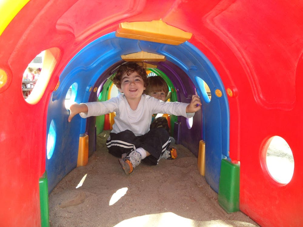 Child in a colorful play tunnel