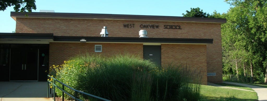 Brick building with "HILL SCHOOL" visible on the facade
