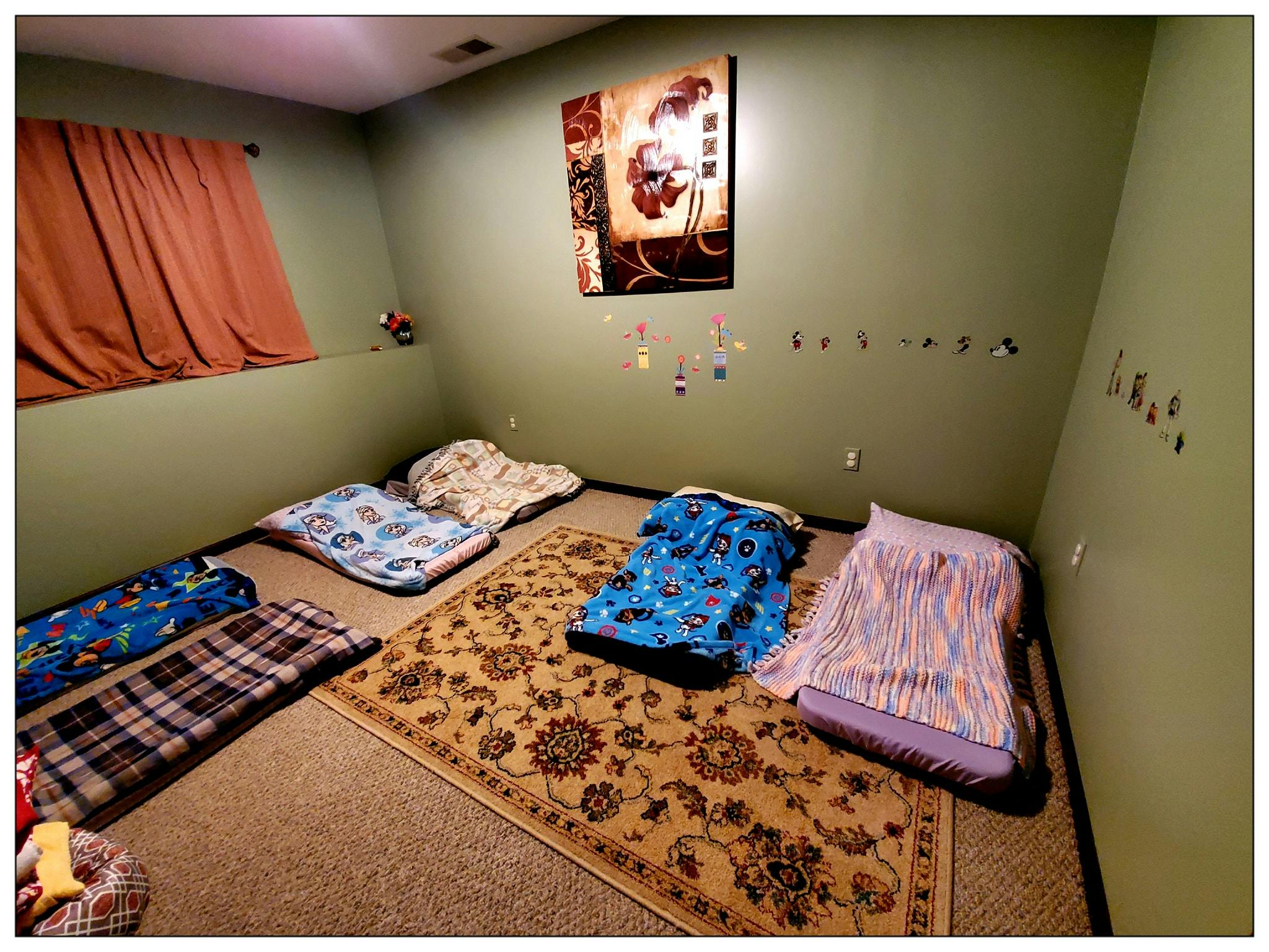Sleeping bags and blankets on the floor in a room