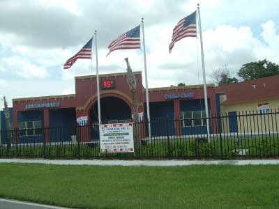 Building with three American flags flying in front
