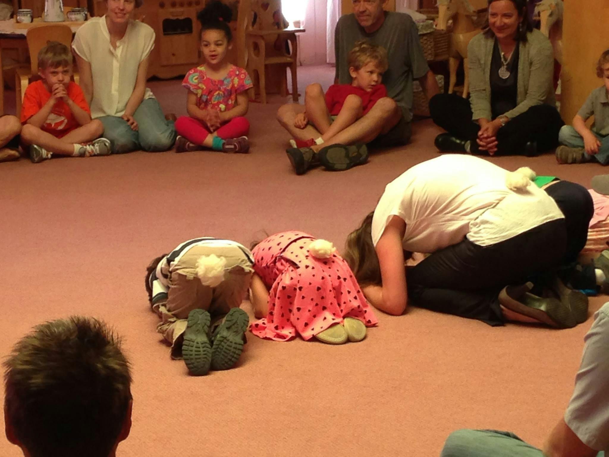 People sitting on the floor, some with heads down