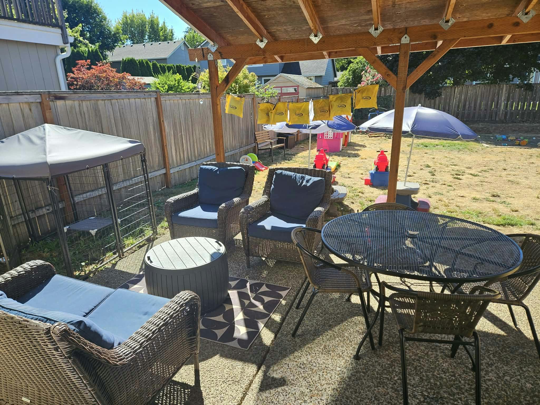 Patio furniture and backyard play area with chairs and tables