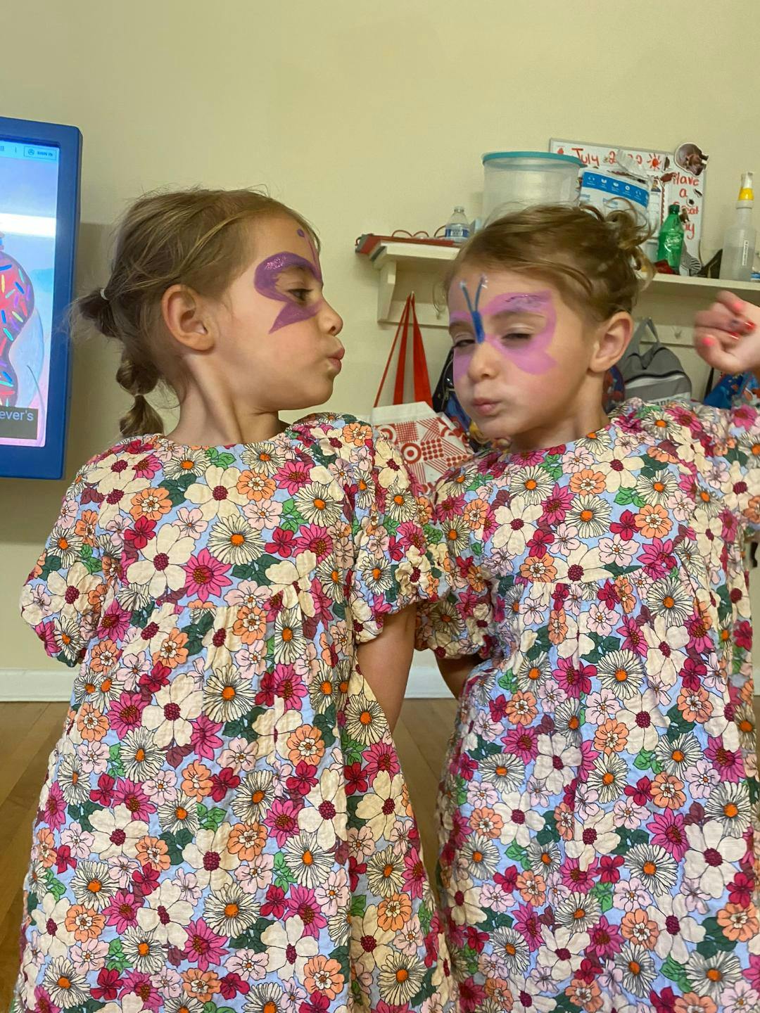 Two children with face paint on their cheeks