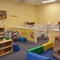 Playroom with soft play equipment and cribs