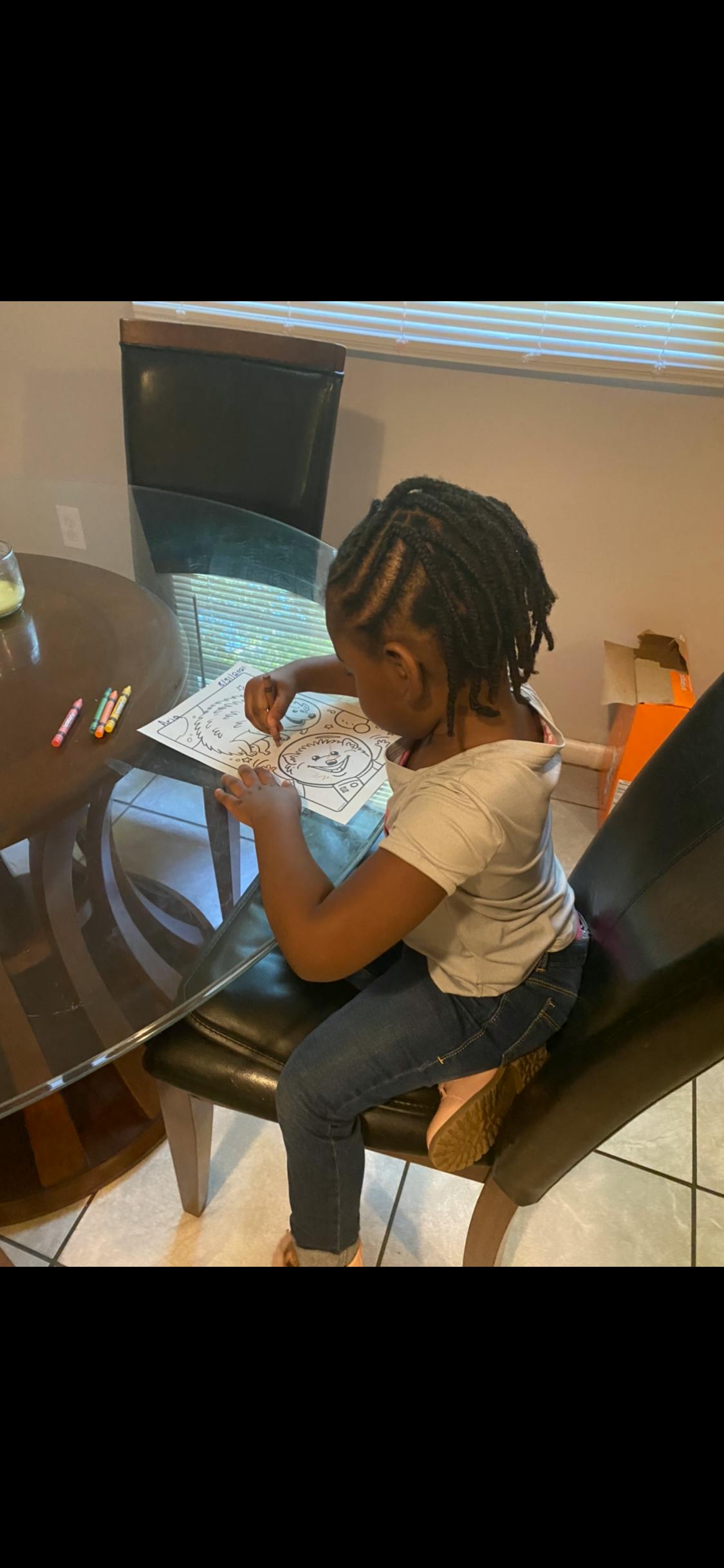 Child coloring at a table