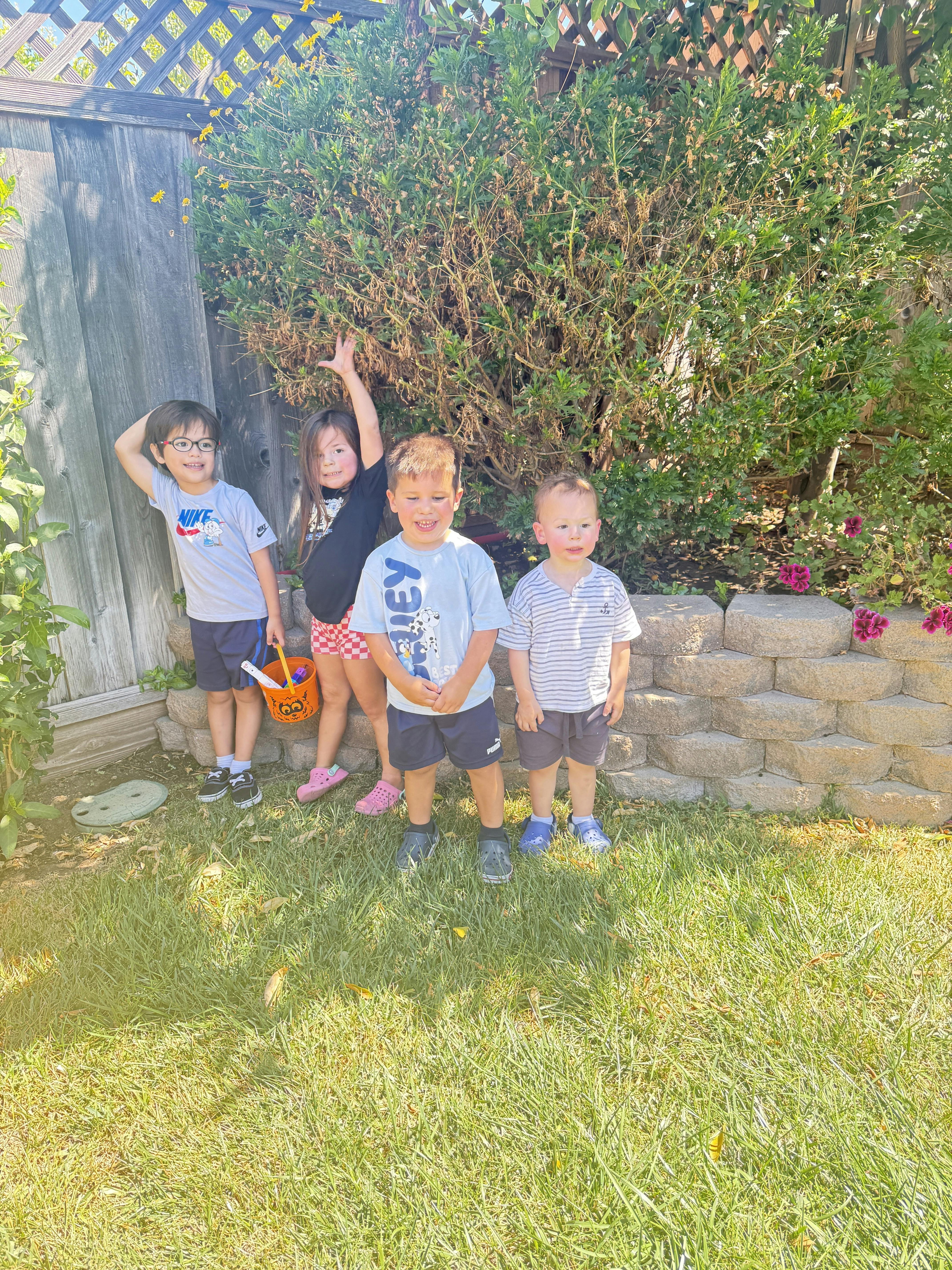 Four children standing in a backyard