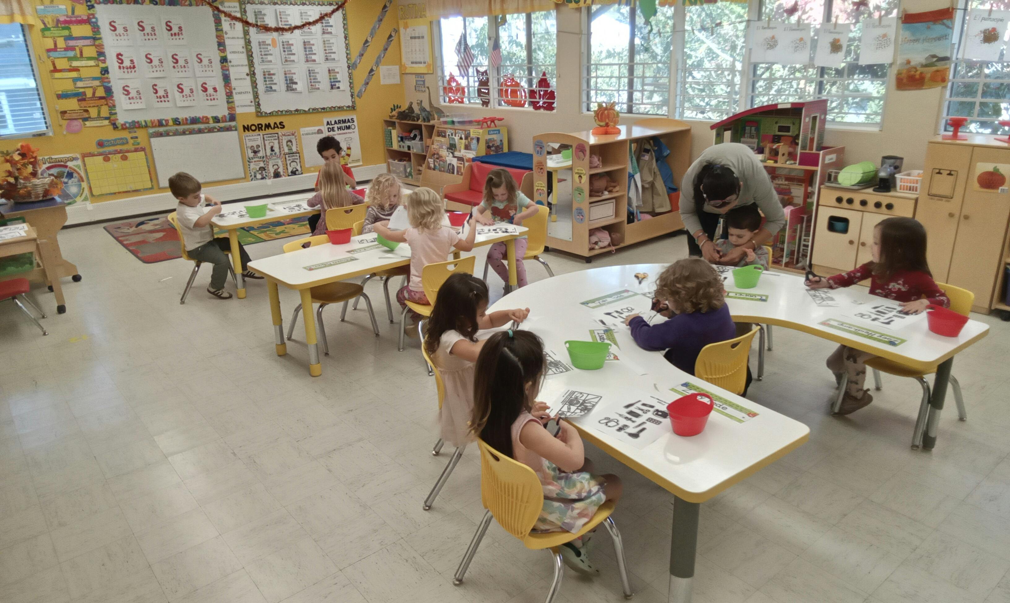 Children sitting at tables in a classroom