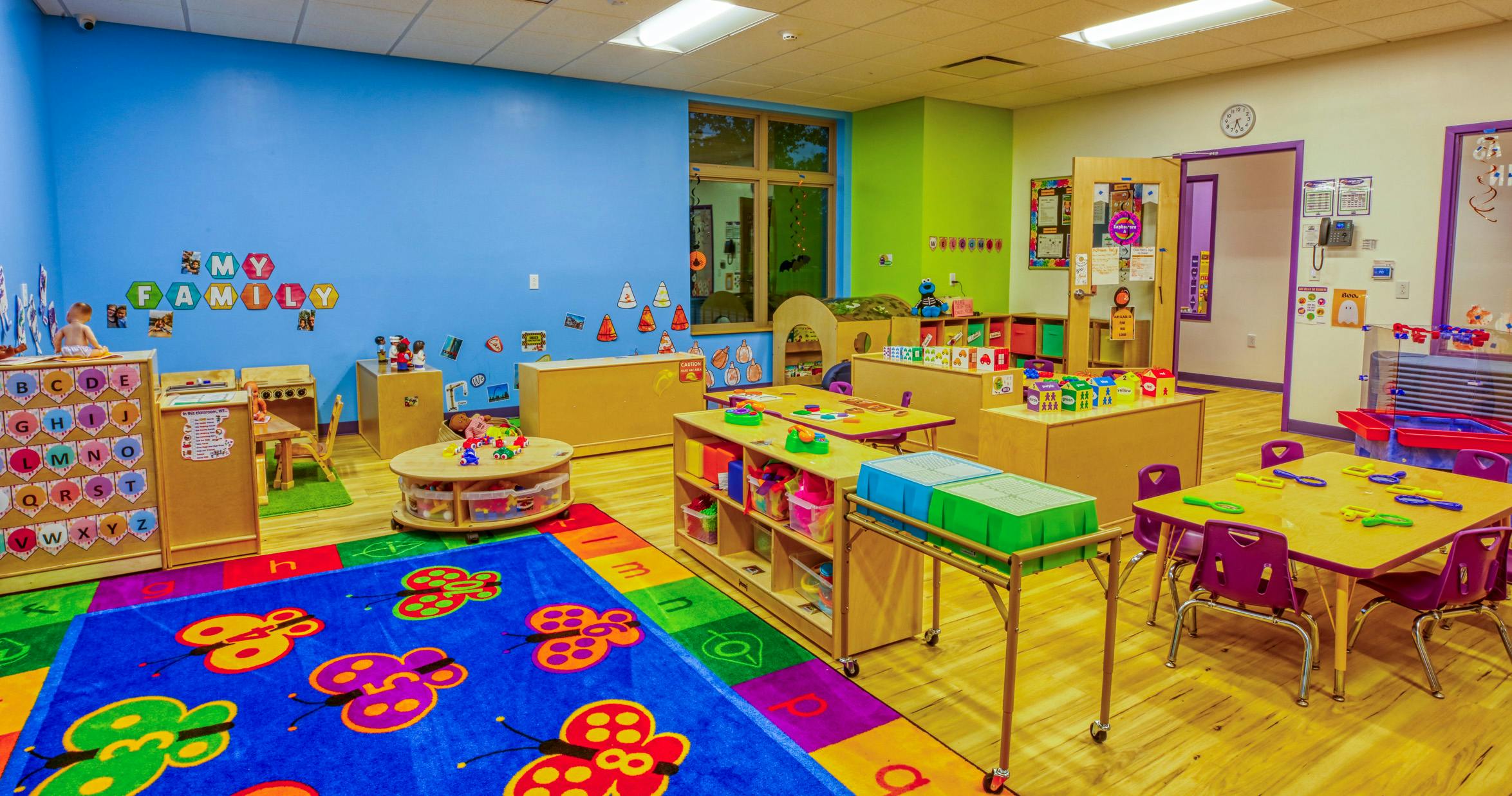 Colorful playroom with alphabet displays, tables, and toys
