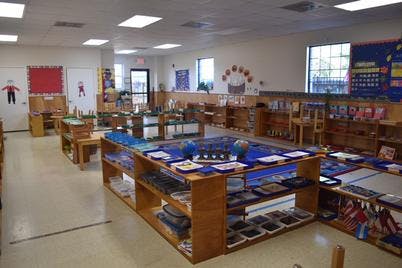 Classroom with wooden shelves and learning materials