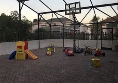Playground with slide, ride-on toys, and basketball hoop