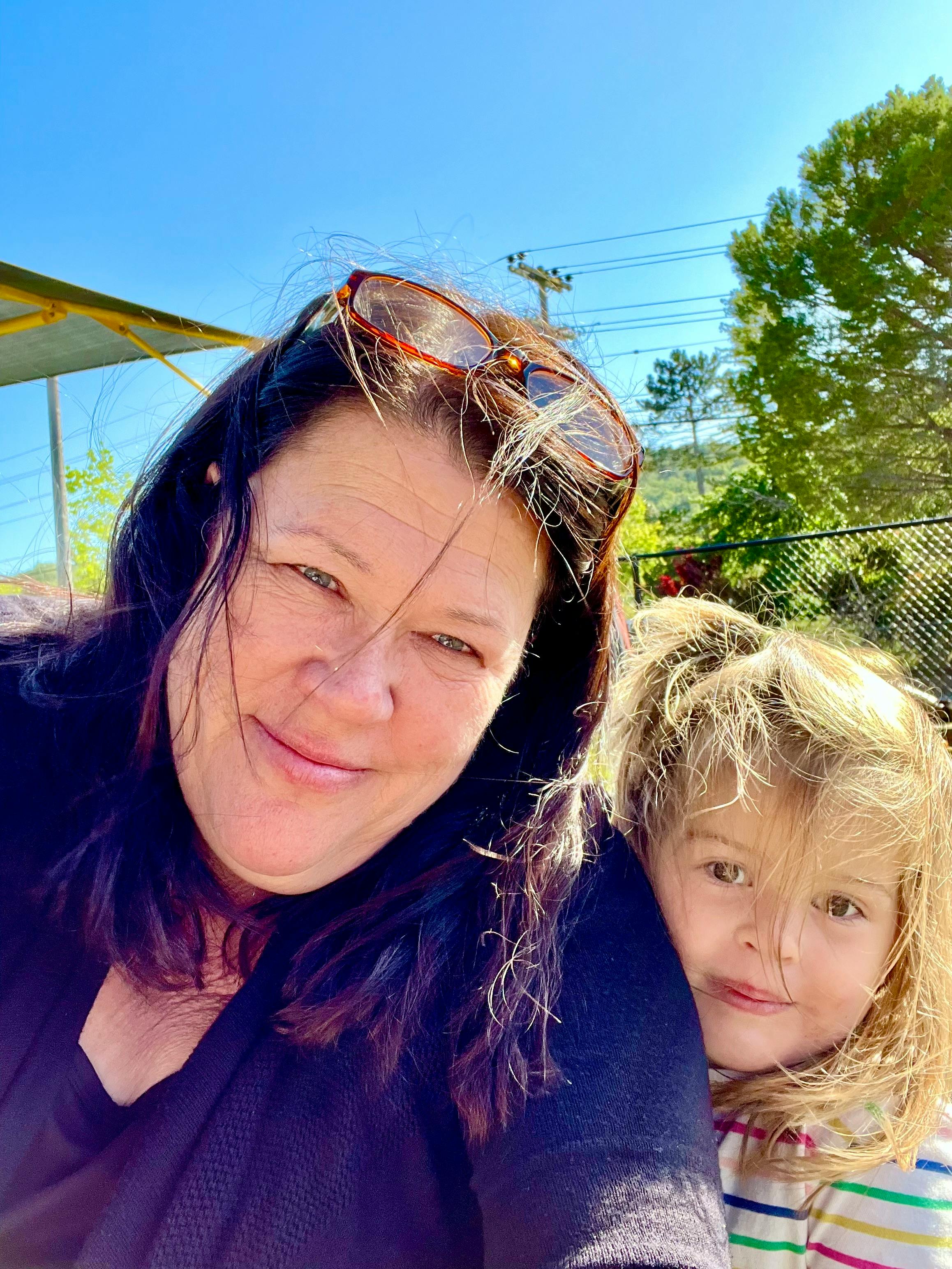Person with sunglasses on head and child with blonde hair