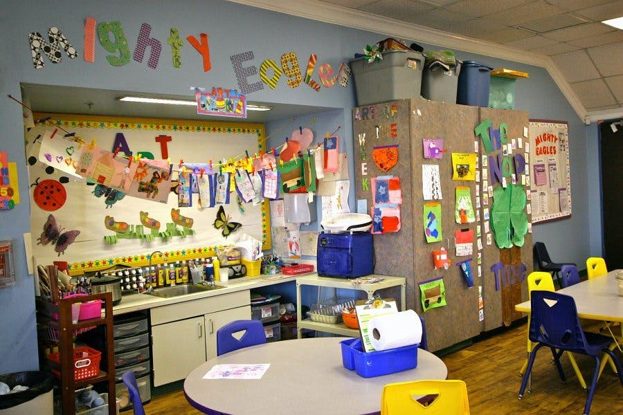 Classroom with art supplies, tables, and chairs