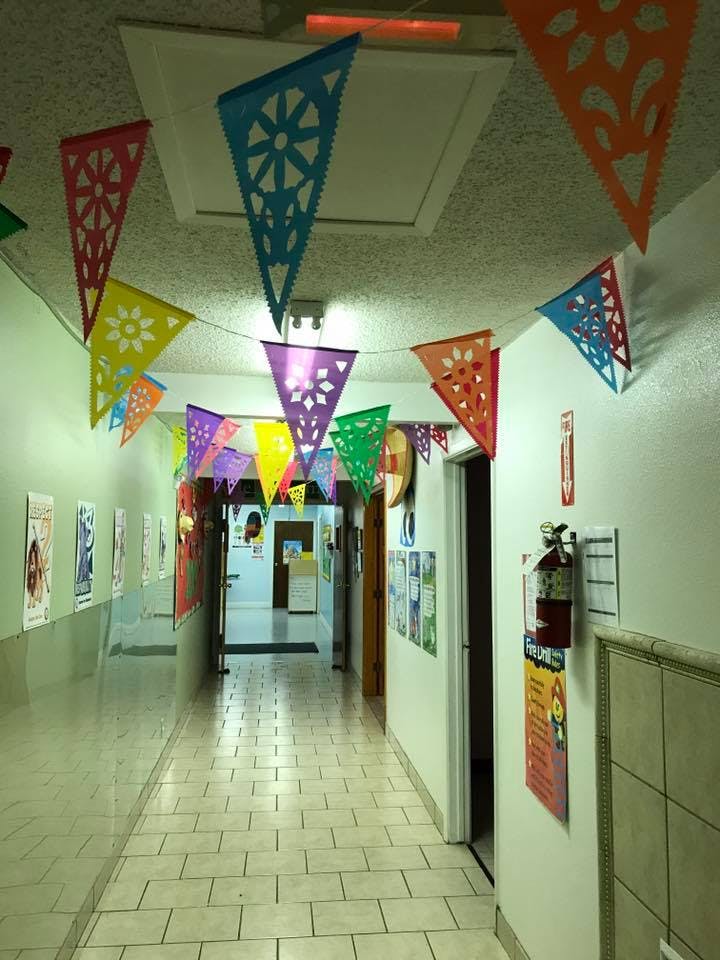Hallway decorated with colorful triangular banners hanging banners