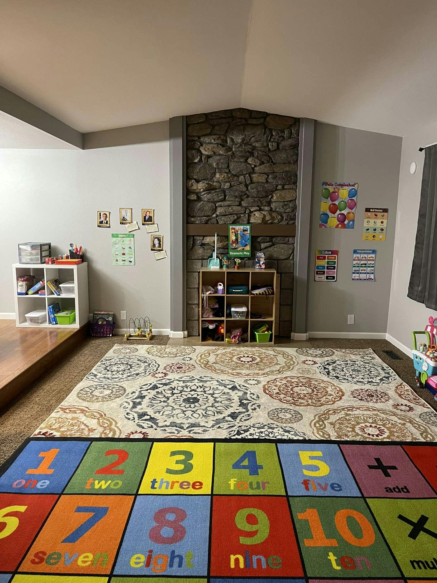 Playroom with a colorful number rug and storage shelves