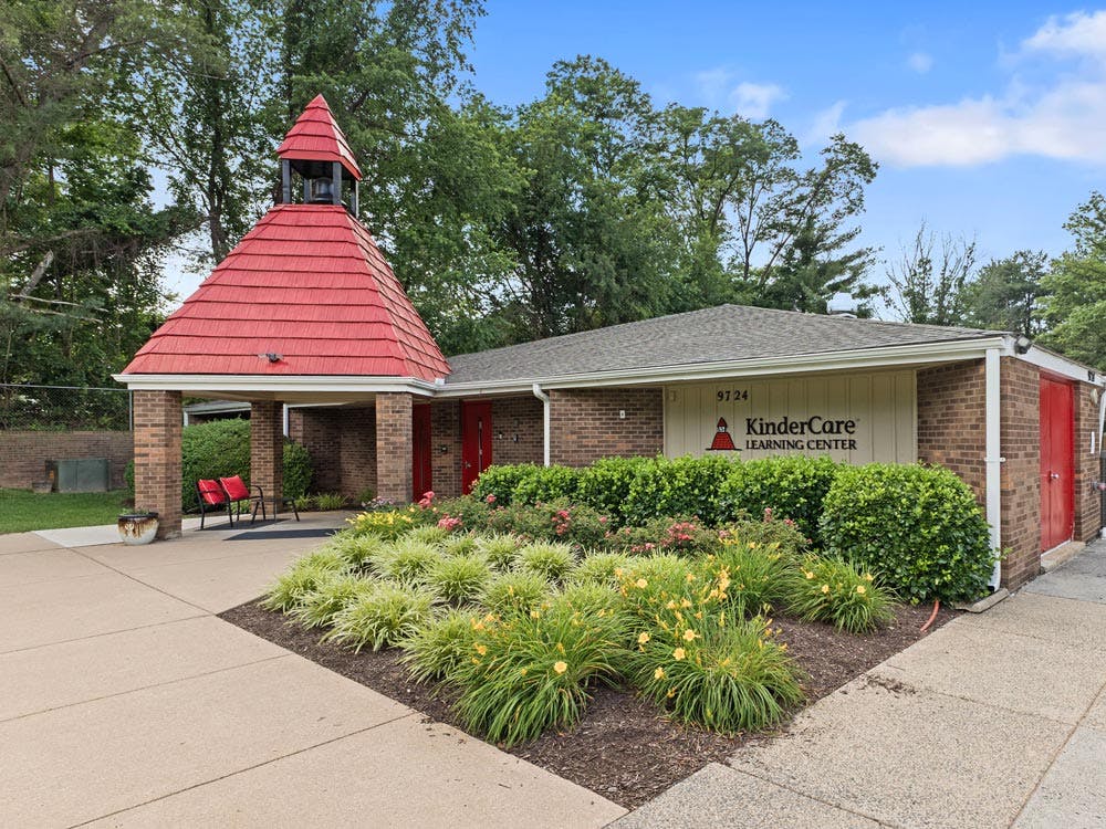 KinderCare Learning Center building exterior with a red roof and bell tower