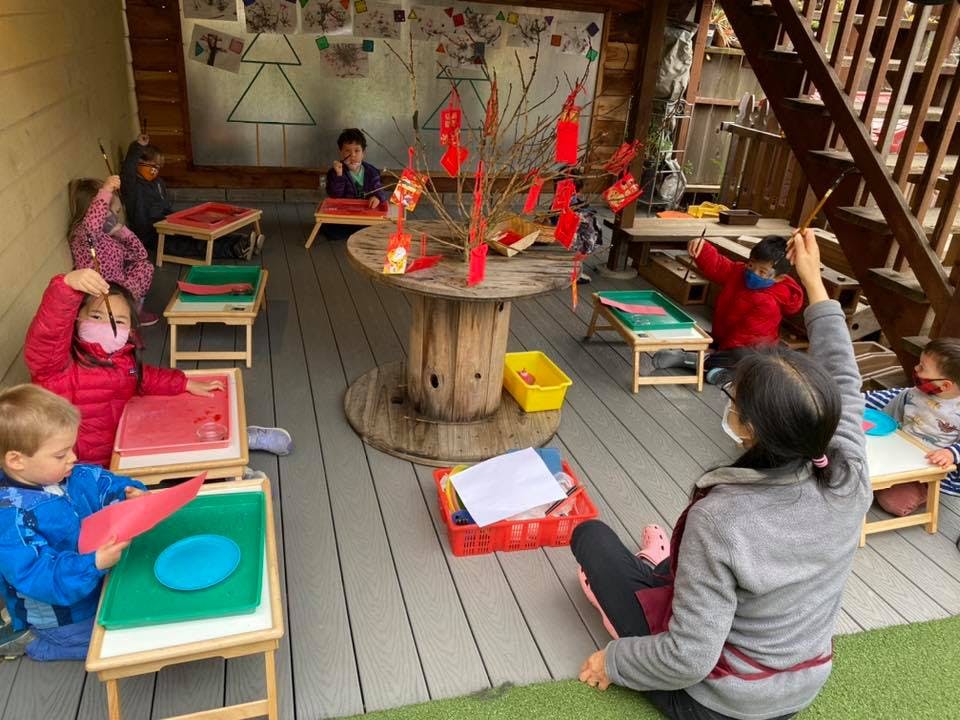 Adult and children in a classroom setting