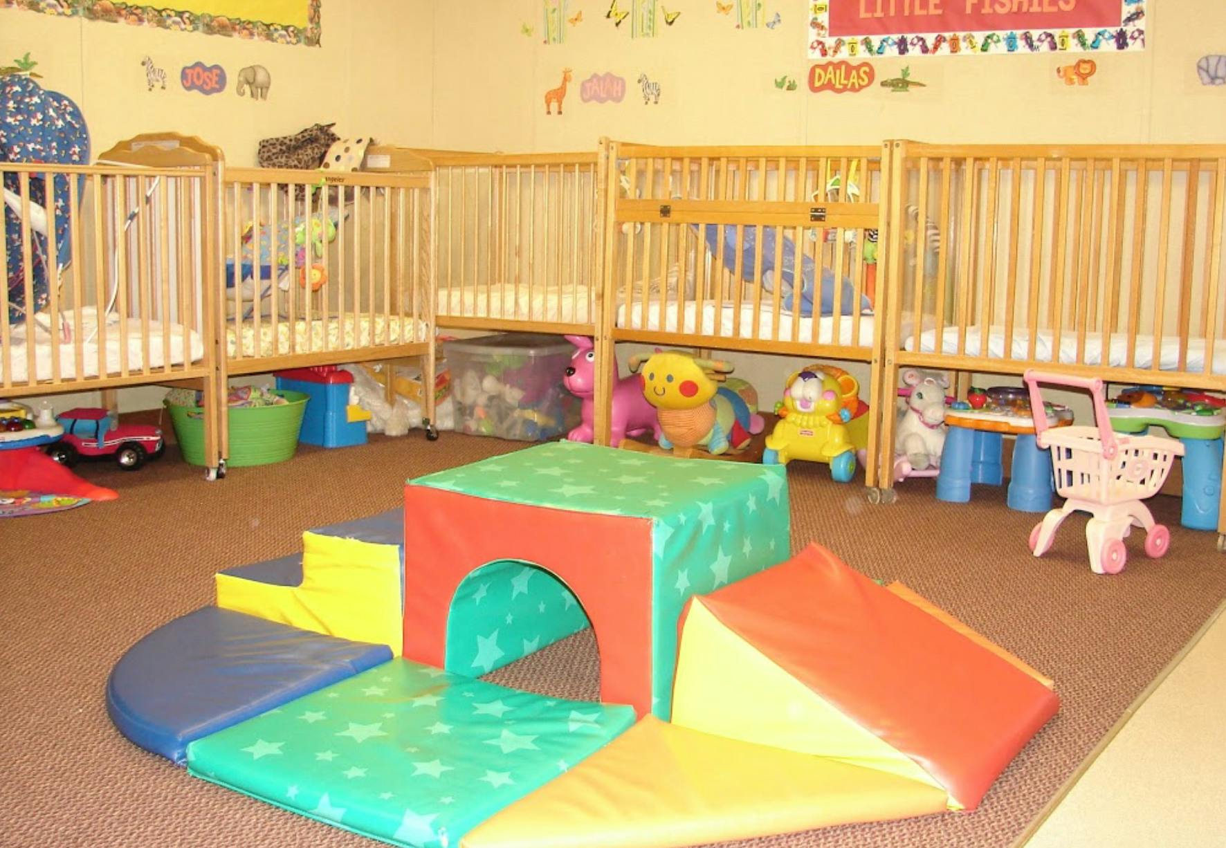 Playroom with soft play equipment and cribs