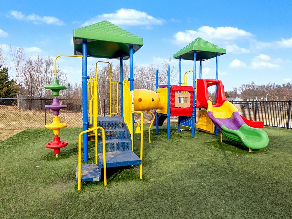 Colorful playground with slides and climbing structures on green turf