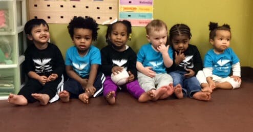 Six children sitting on the floor