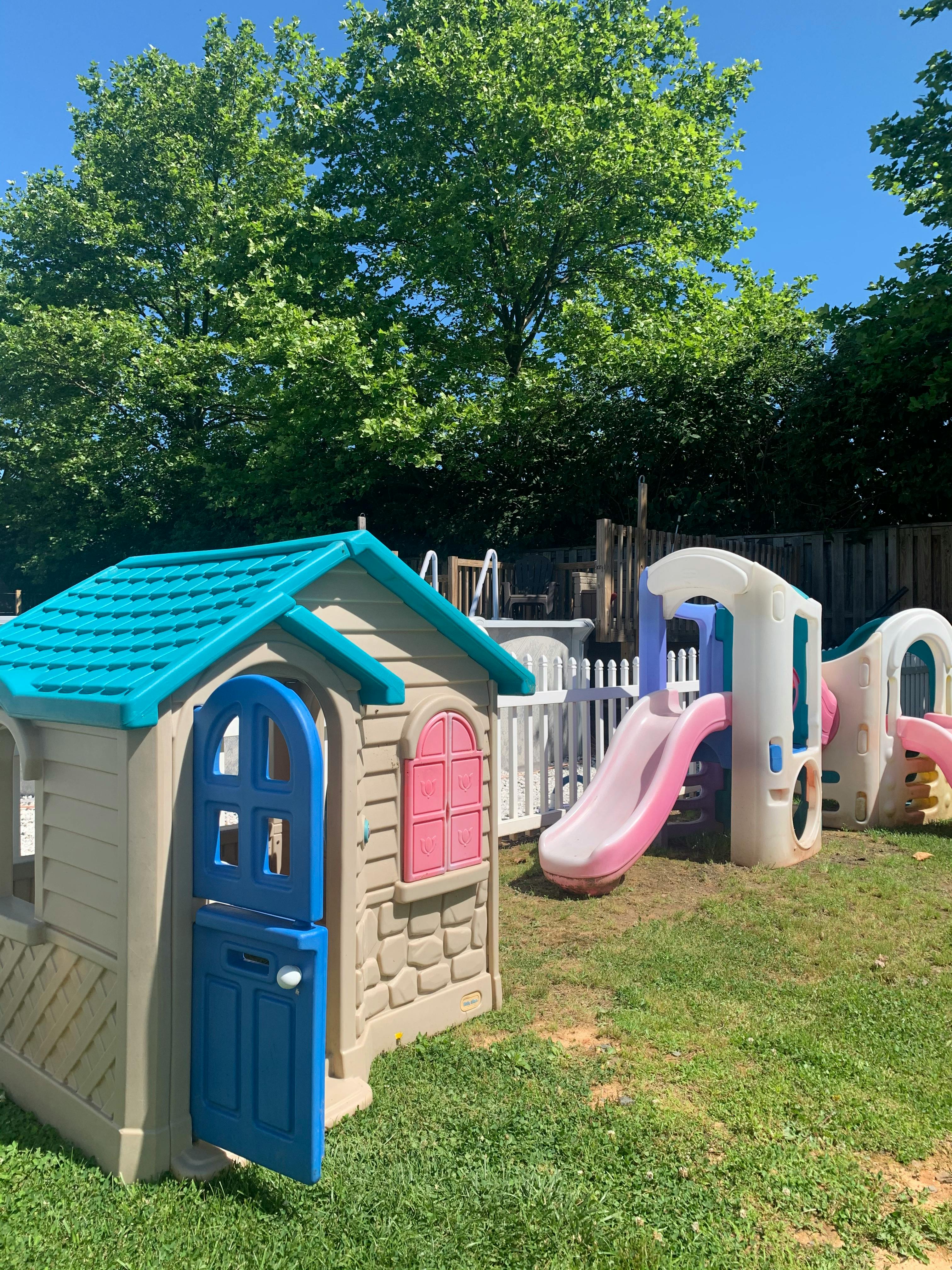 Playhouse and slide on a grassy lawn