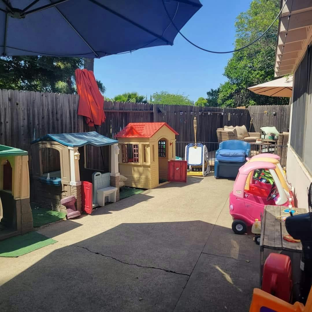 Backyard patio with children's playhouses and toys