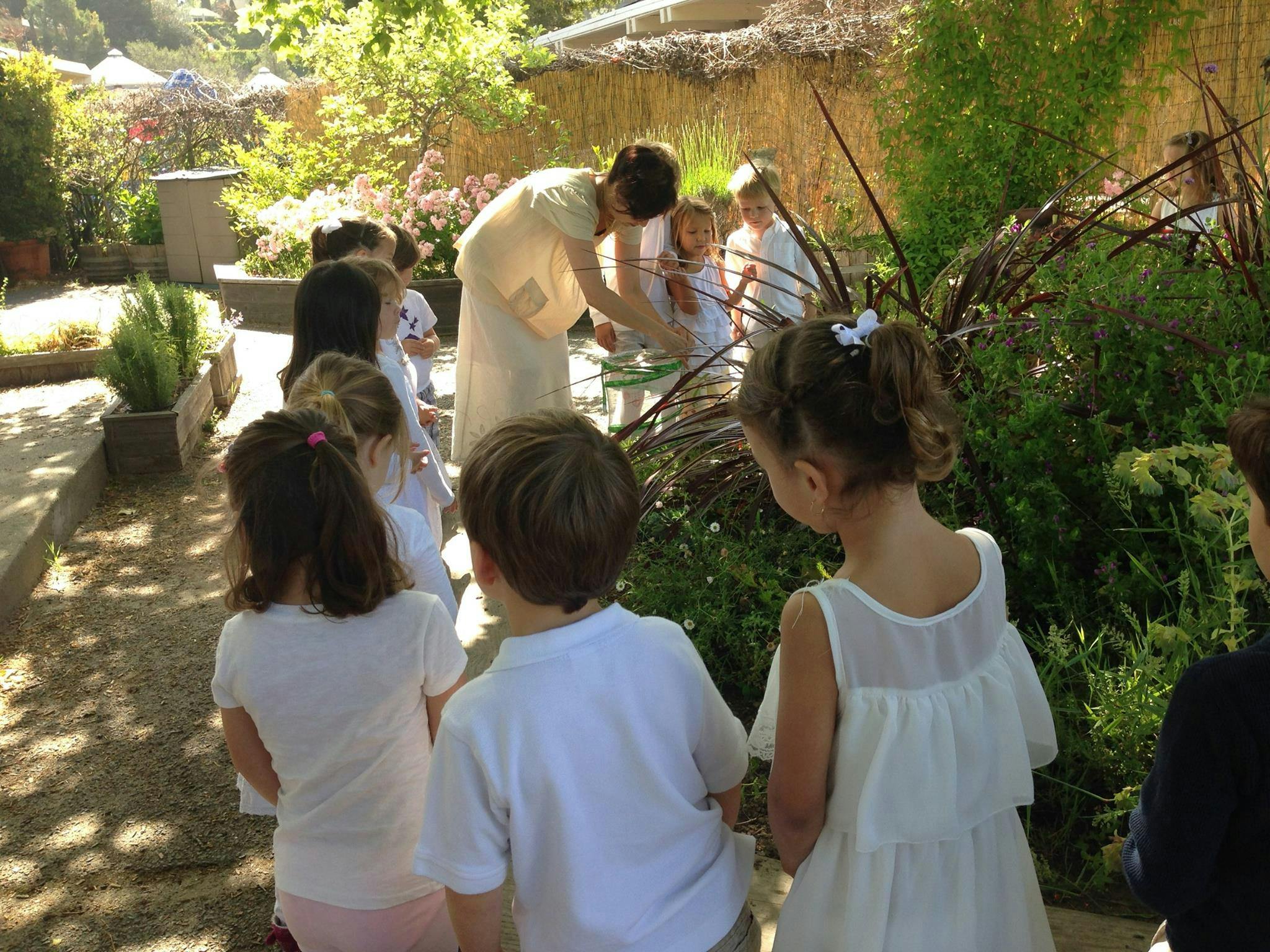 Adult interacting with children outdoors
