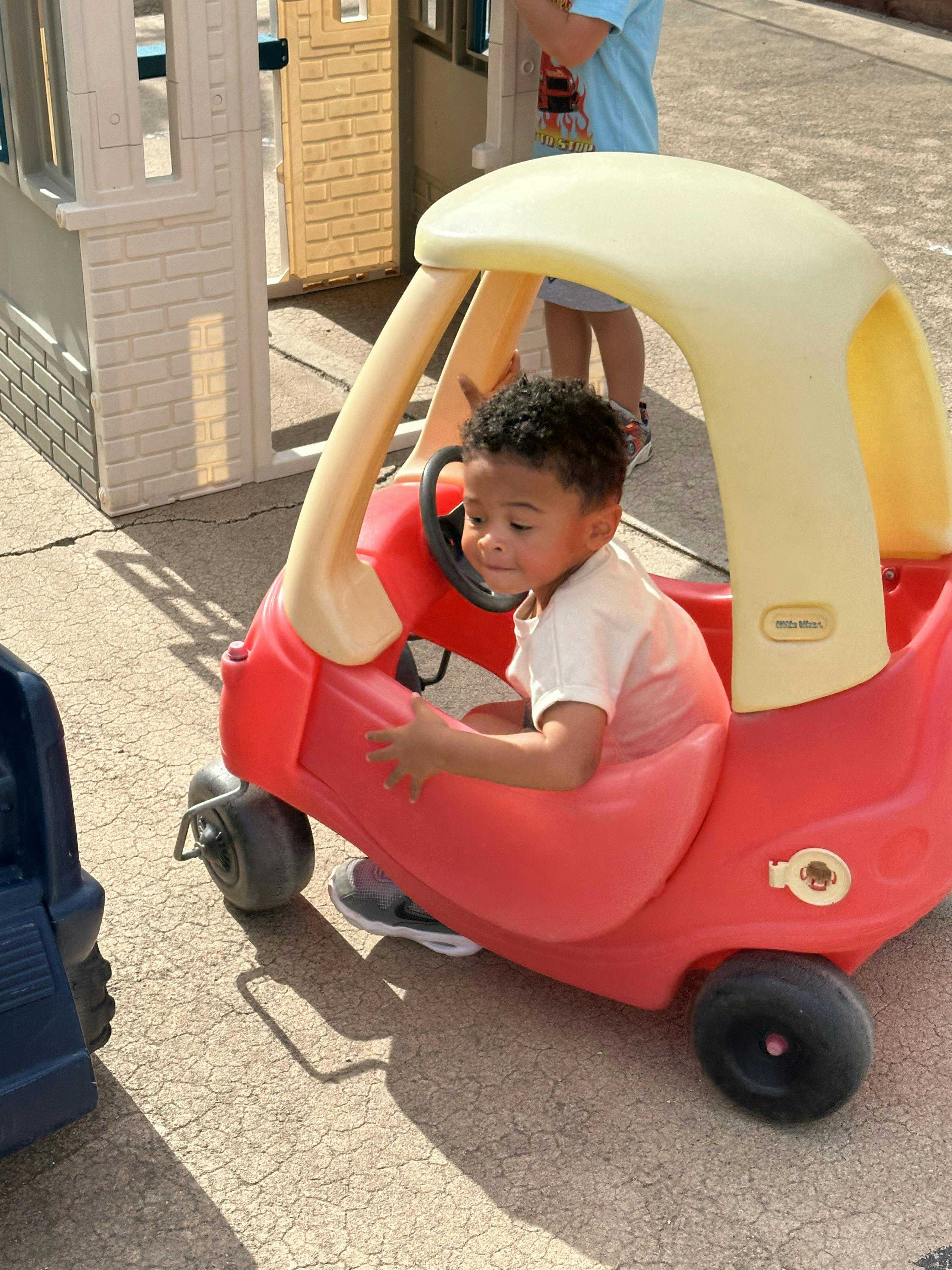 Child in a toy car