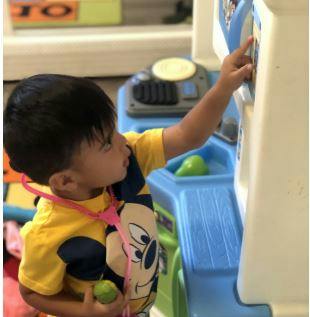 Child playing with a toy medical station