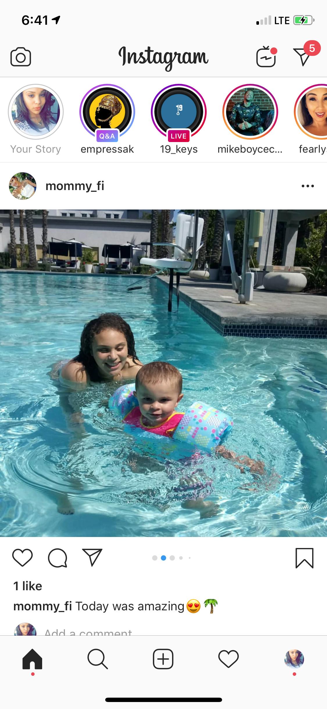 Person in a pool with a child wearing arm floaties