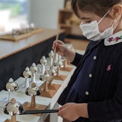 Child in mask playing chimes