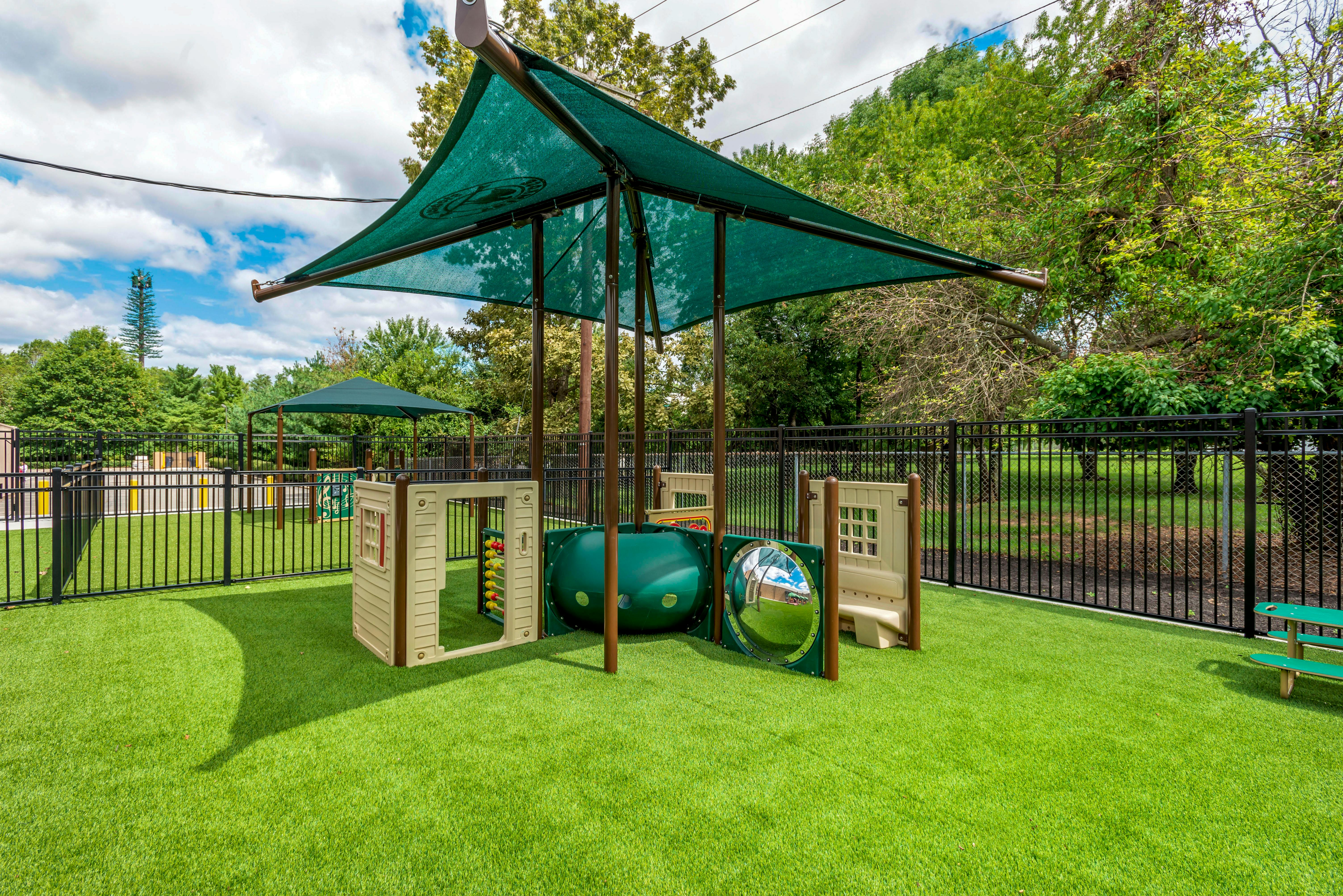 Playground with green turf and shades