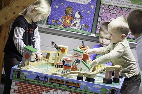 Children playing with a toy train set