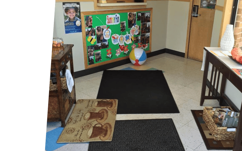 Bulletin board with photos and a beach ball on the floor