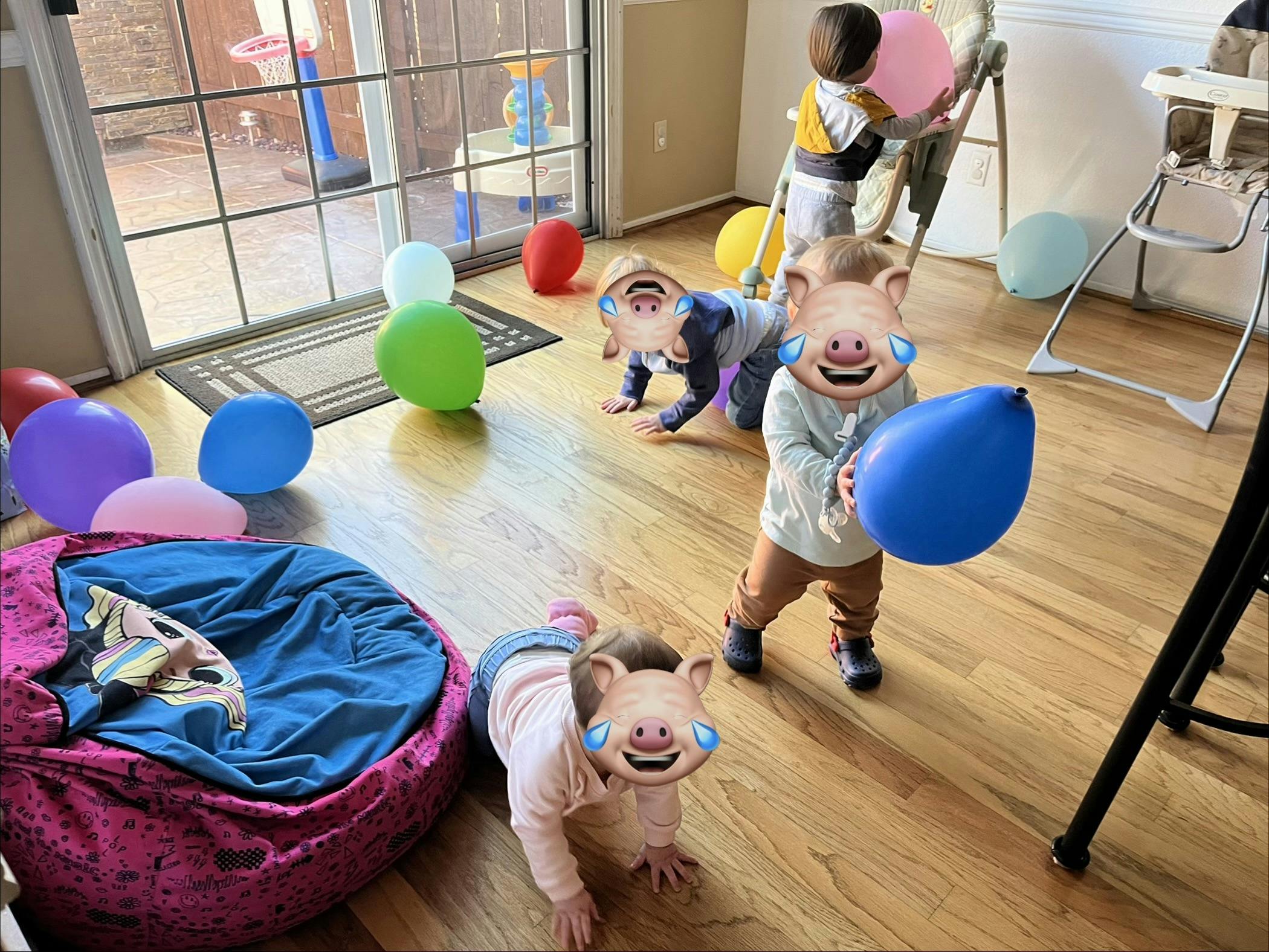 children playing with balloons on a hardwood floor
