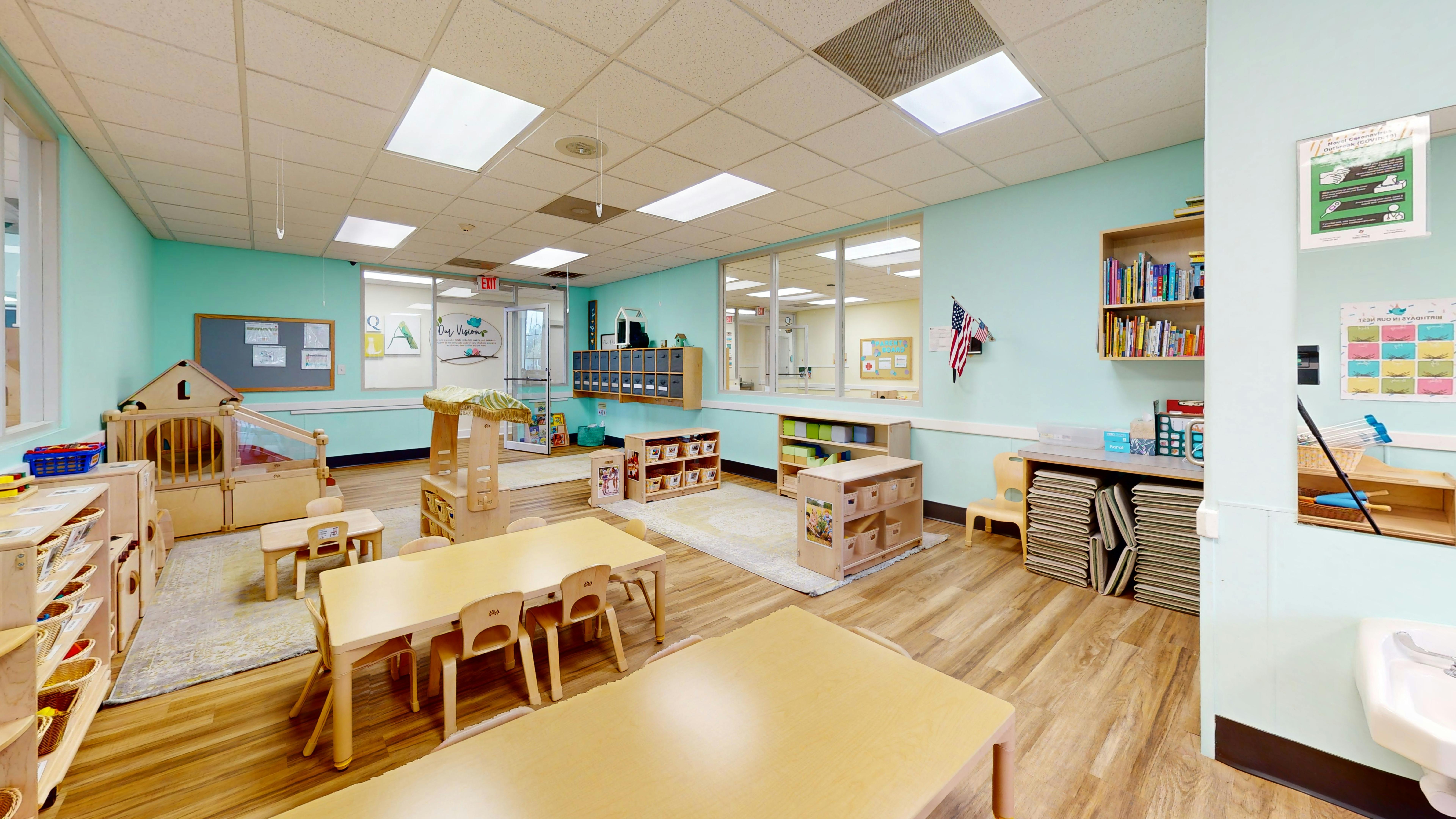 Empty classroom with small tables and chairs