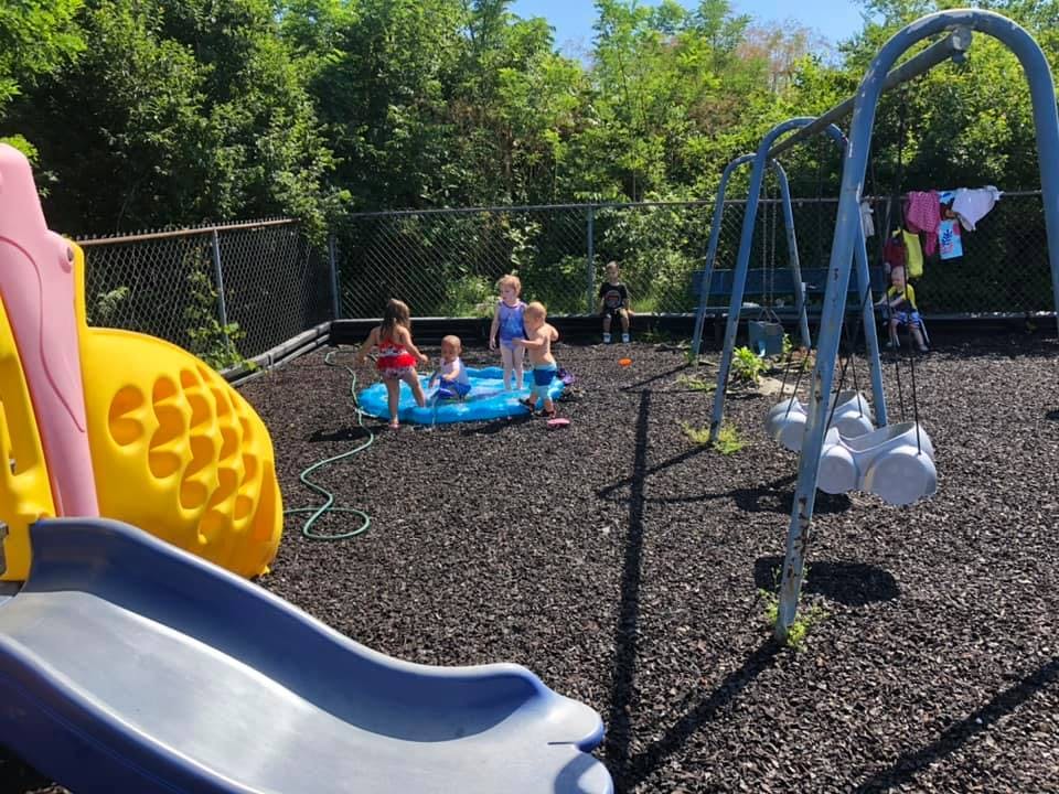 Children playing in a small pool on a playground