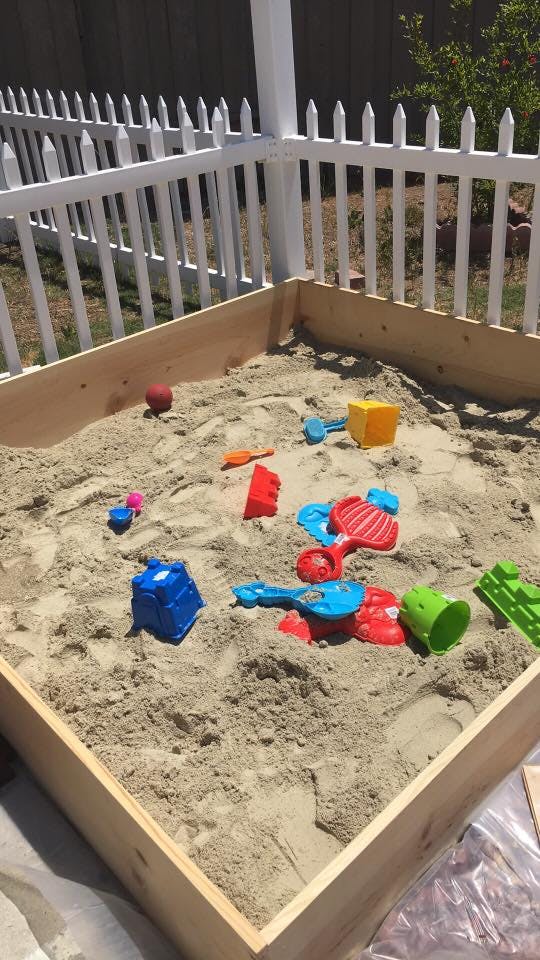Sandbox with various colorful toys