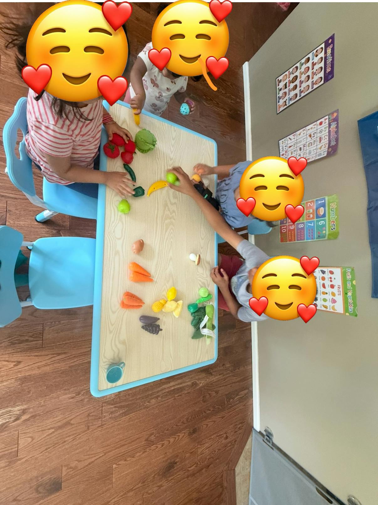 Children playing with toy food at a table