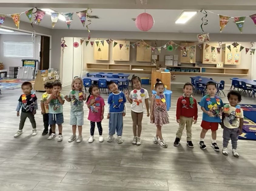 Group of children standing in a classroom
