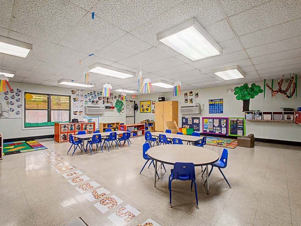 Empty classroom with small tables and chairs