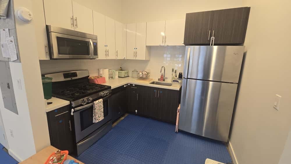 Kitchen with stainless steel appliances and white and dark cabinets