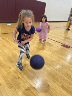 Child playing with a ball indoors