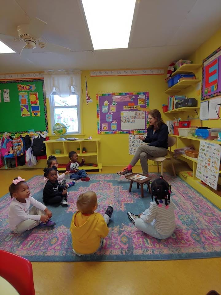 Person reading to children in a classroom