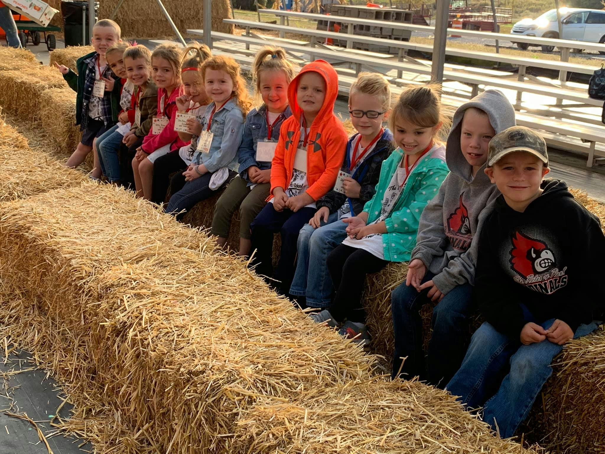 Group of children sitting on hay bales