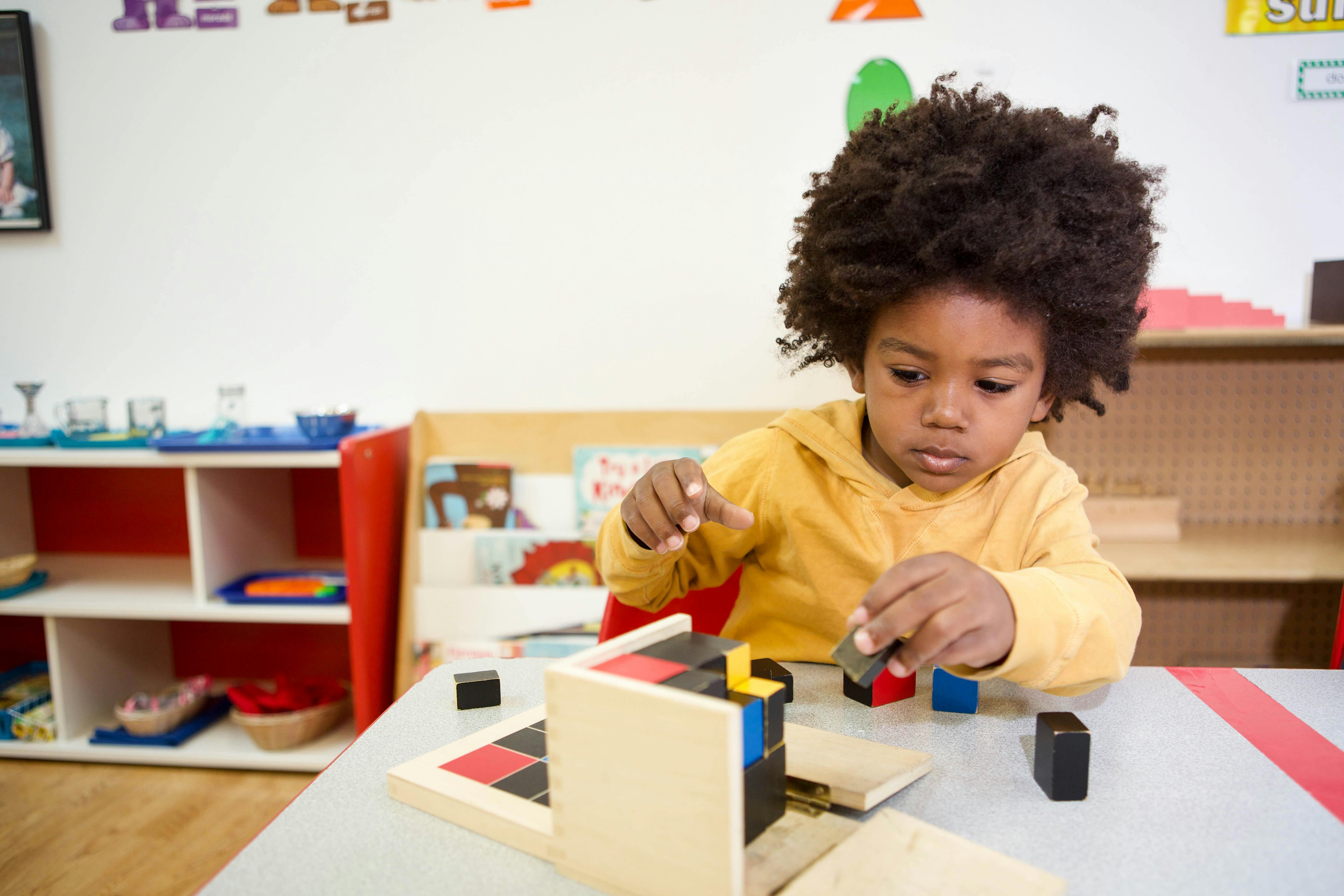 Child playing with blocks at a table